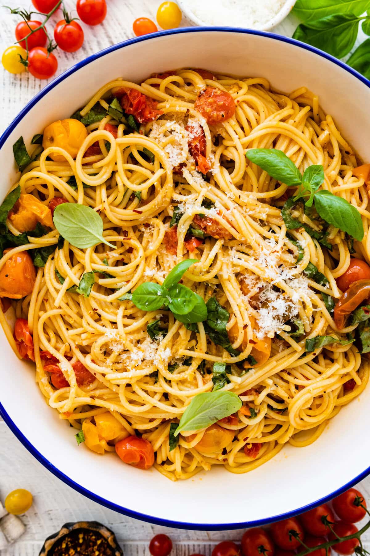 how to make easy burst cherry tomato pasta step-by-step instructions: garnish pan with basil leaves.