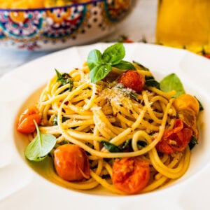 Cherry tomato pasta on a white plate.