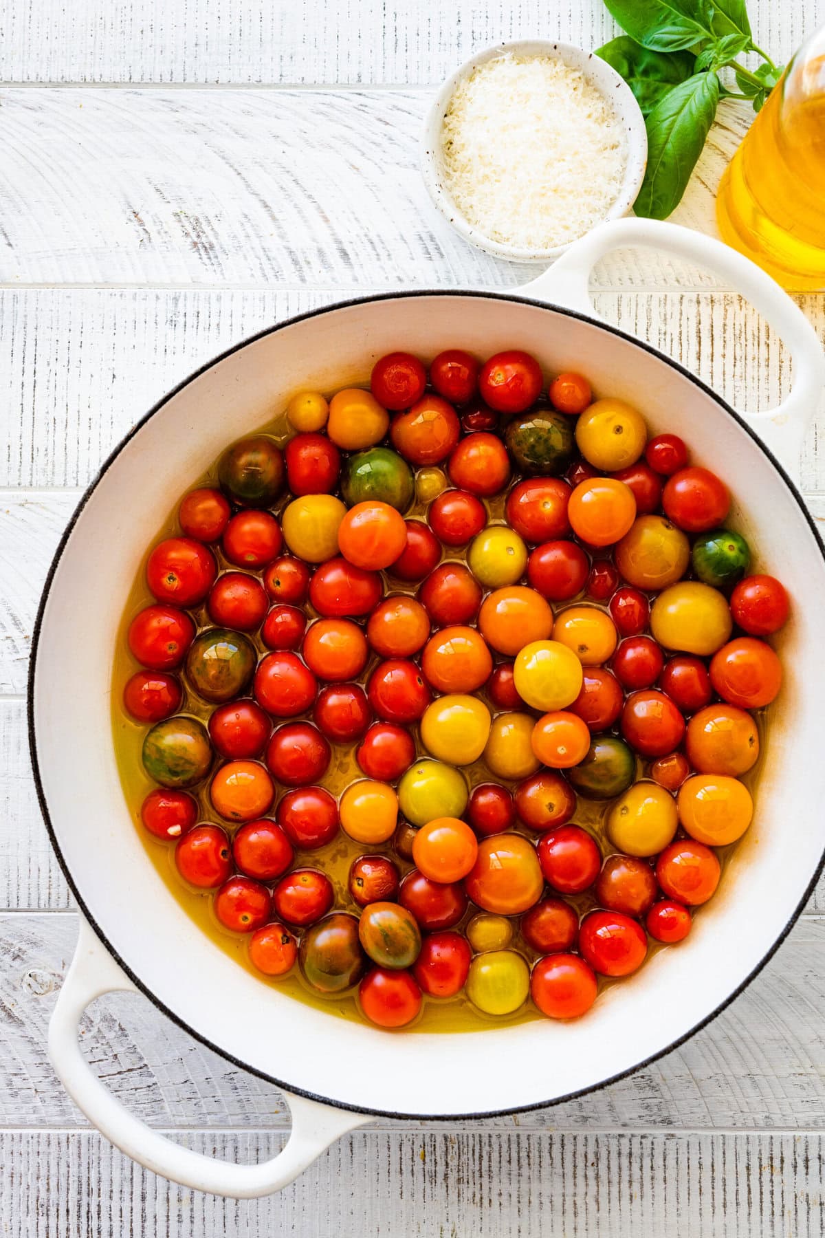 how to make easy burst cherry tomato pasta step-by-step instructions: heating olive oil and garlic in the pan. Adding the cherry tomatoes.