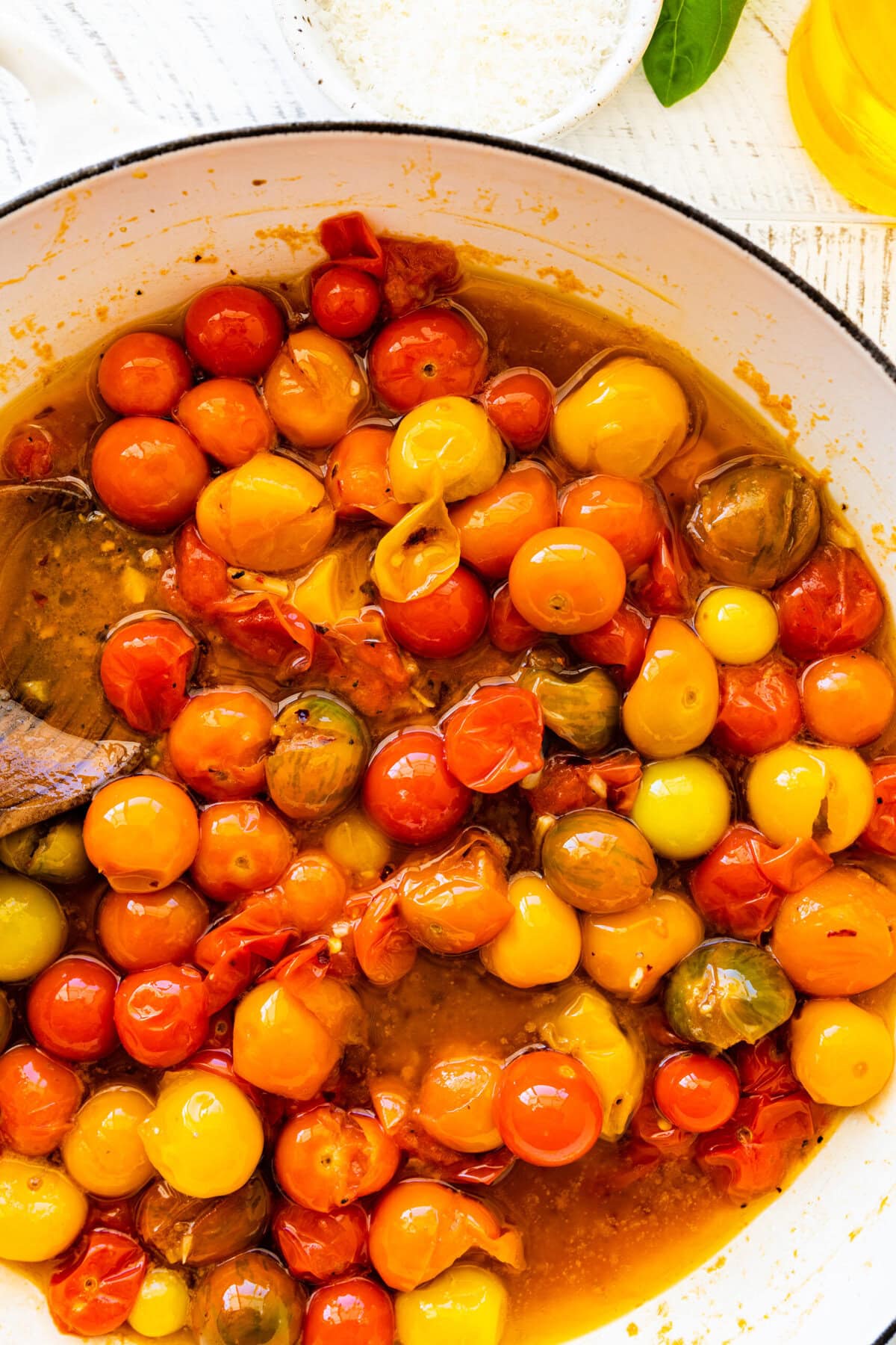 how to make easy burst cherry tomato pasta step-by-step instructions: cooking the cherry tomatoes until they burst. Smash with the back of a spoon.