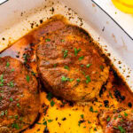 How to make easy juicy oven baked pork chops recipe step-by-step: baked pork chops in pan.