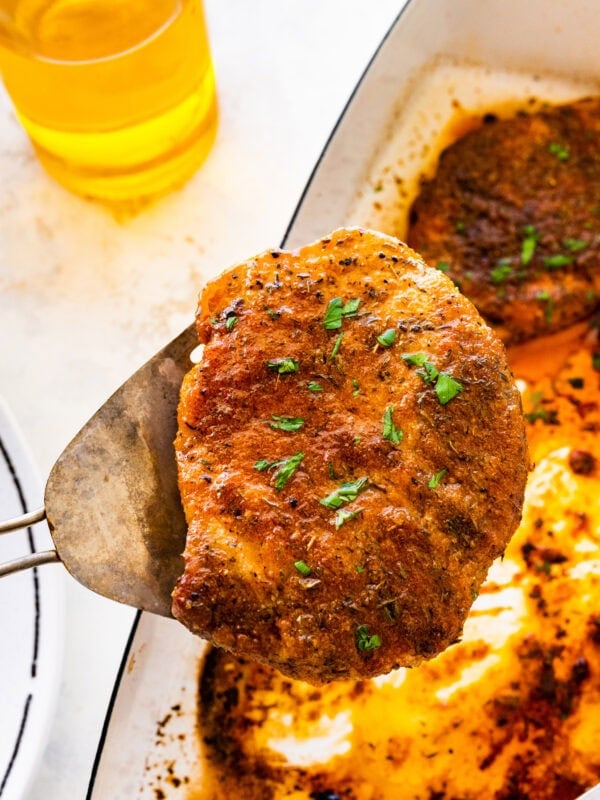 spatula holding easy oven baked pork chops. Ready to serve.
