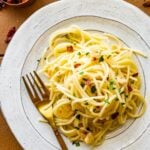 Fork on a plate with spaghetti aglio e olio.