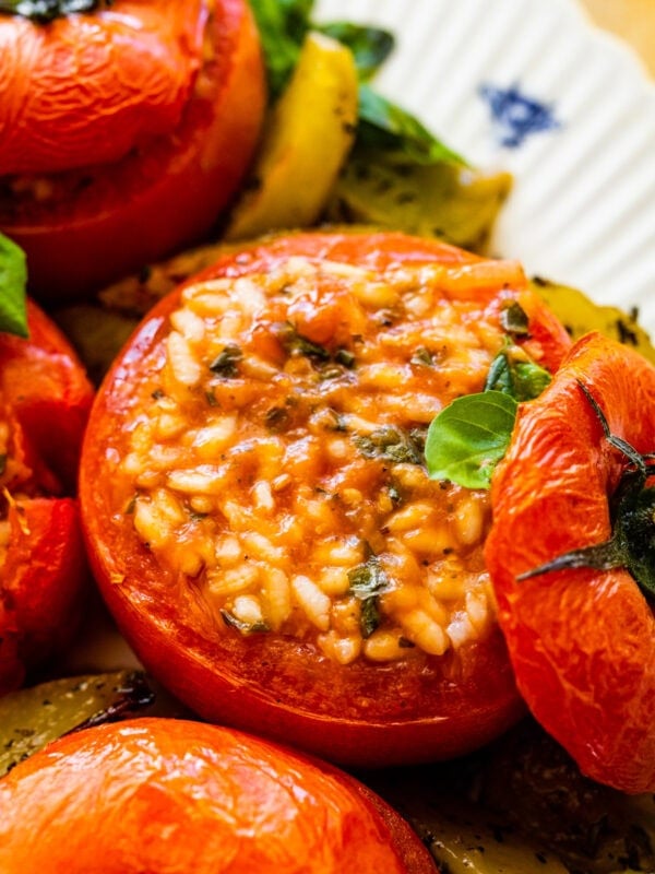 BEST Stuffed Tomatoes with Rice (Pomodori Con Riso) in a pan showing with the top off and the creamy risotto in the tomato.