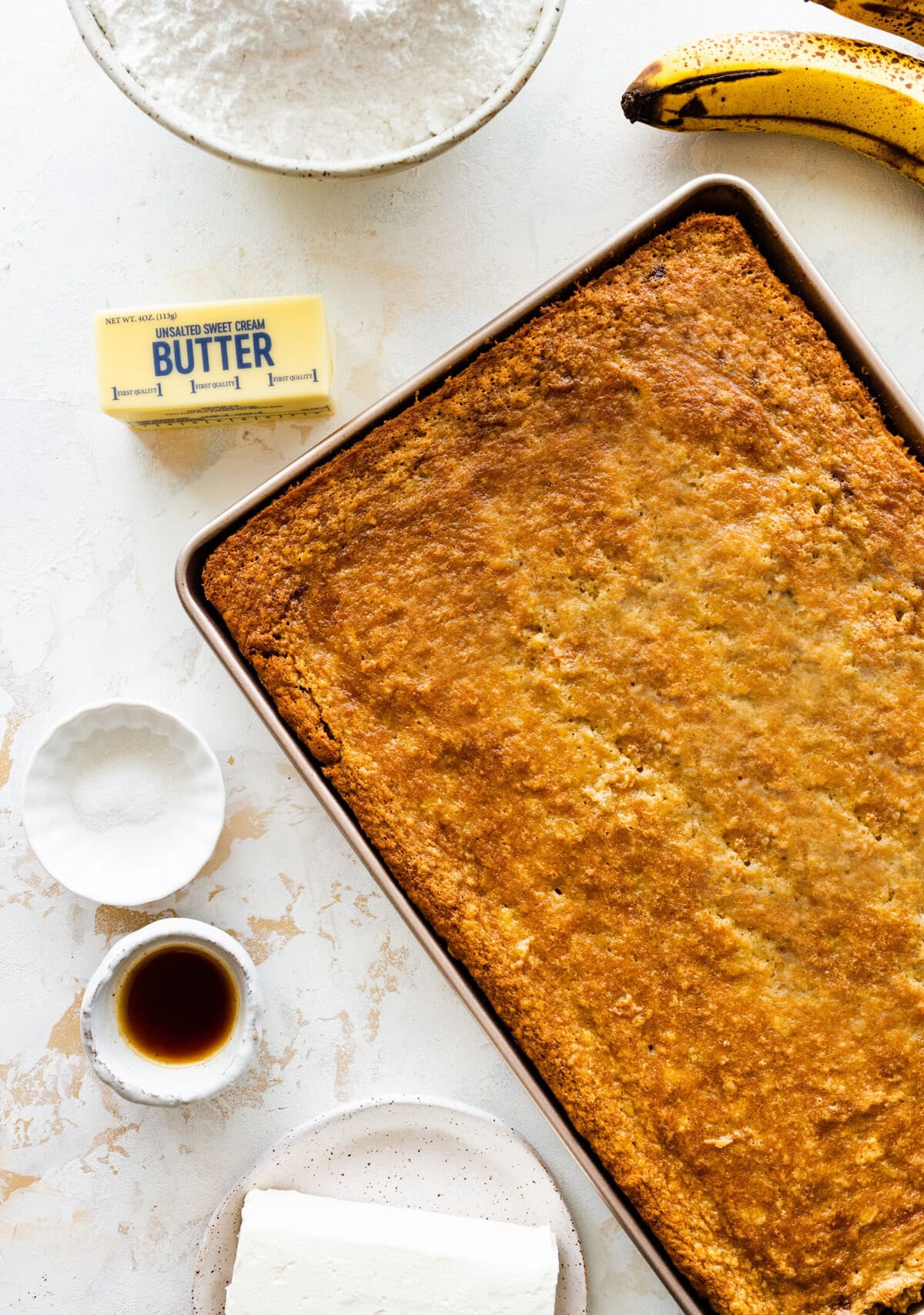baked banana barrs in the baking pan ready for the frosting layer.