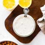 Spoon in a small bowl of Tahini Sauce.