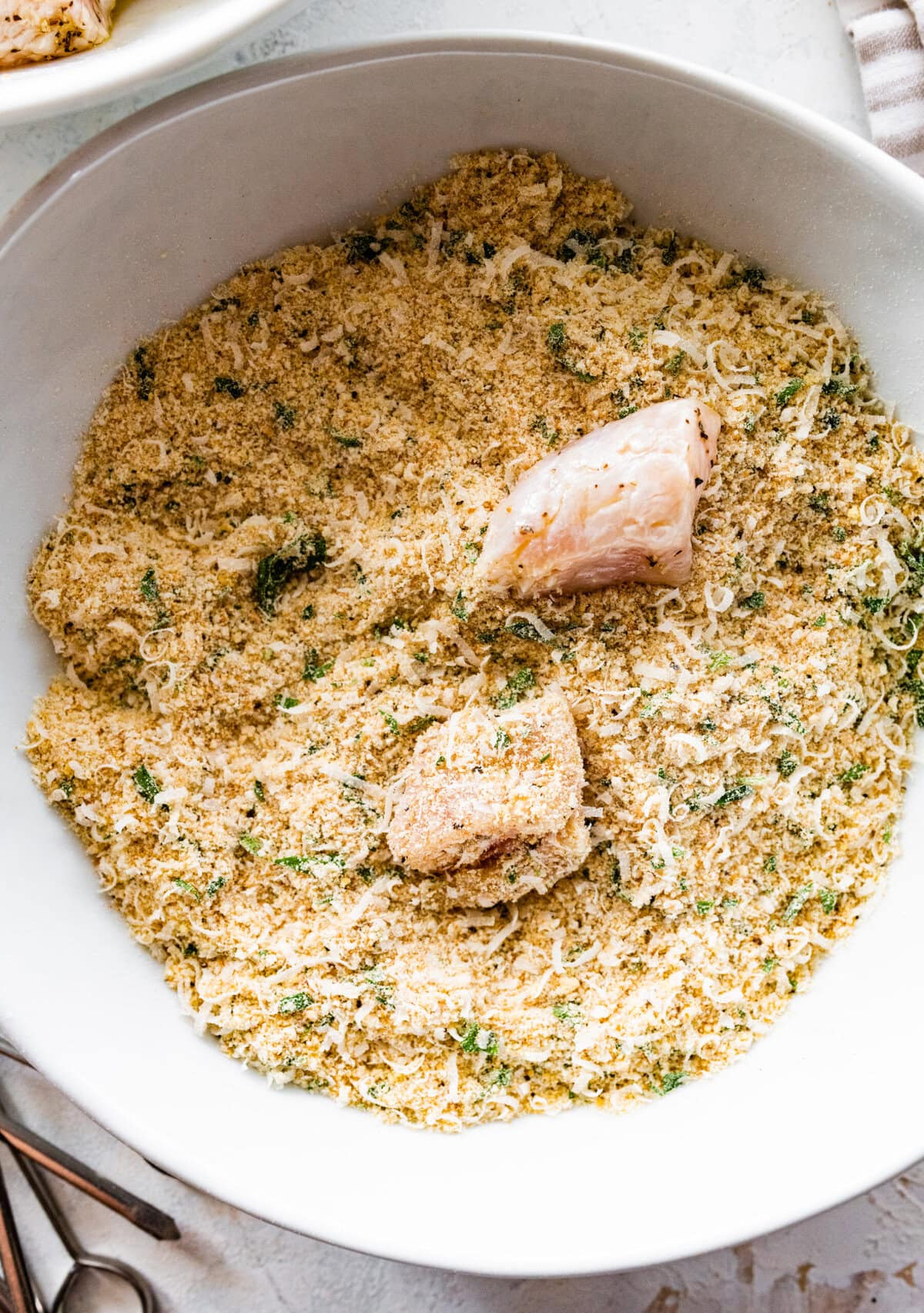 how to make chicken spiedini step-by-step: cover the chicken in the breadcrumb topping.