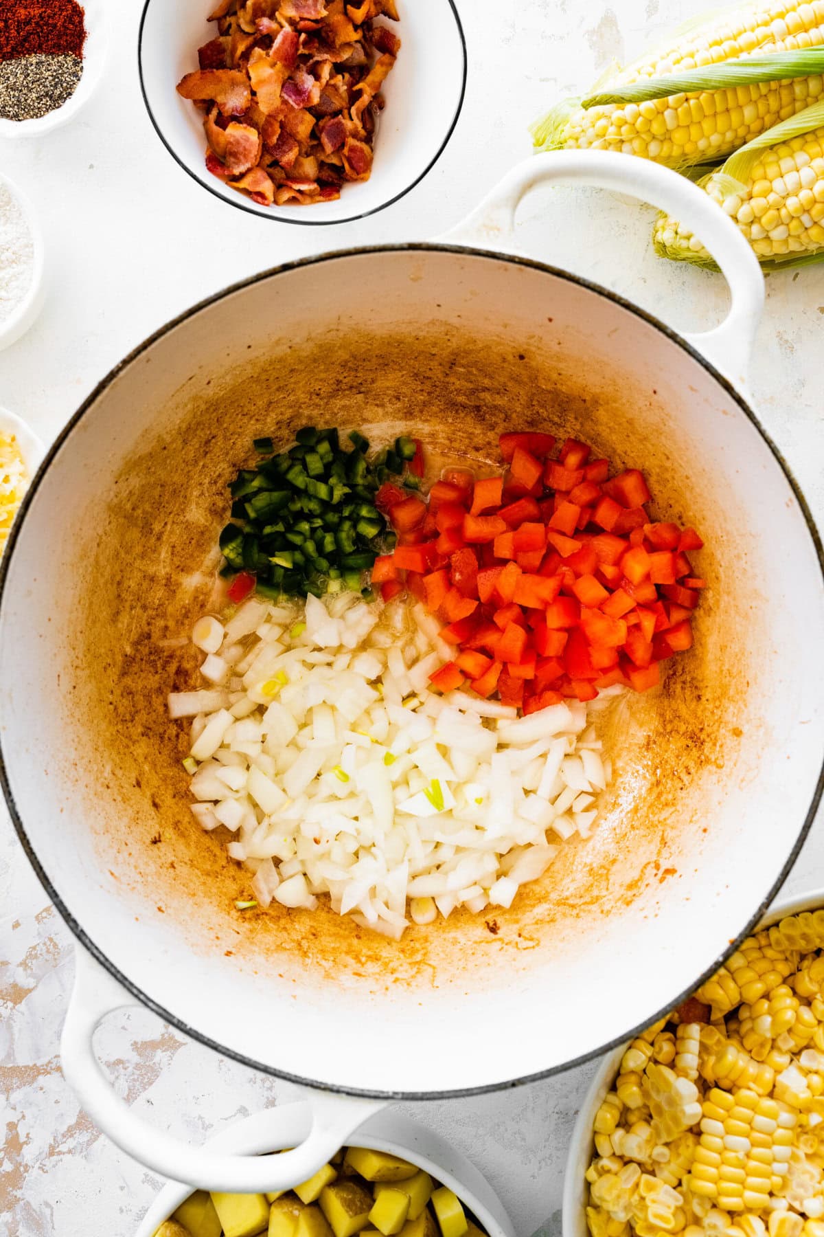 How to make simple summer corn chowder step-by-step: add veggies to the pot and cook.