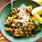 Small bowl of charred corn and zucchini salad with lime and cilantro.