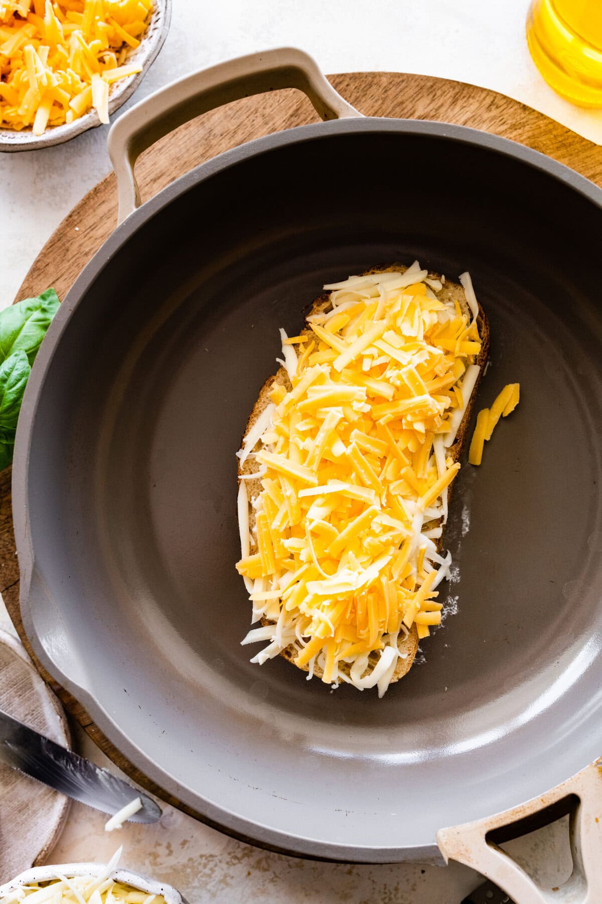how to make the grilled cheese sandwich- butter the bread on both sides. Add the bread to a hot pan and add the cheese on top.