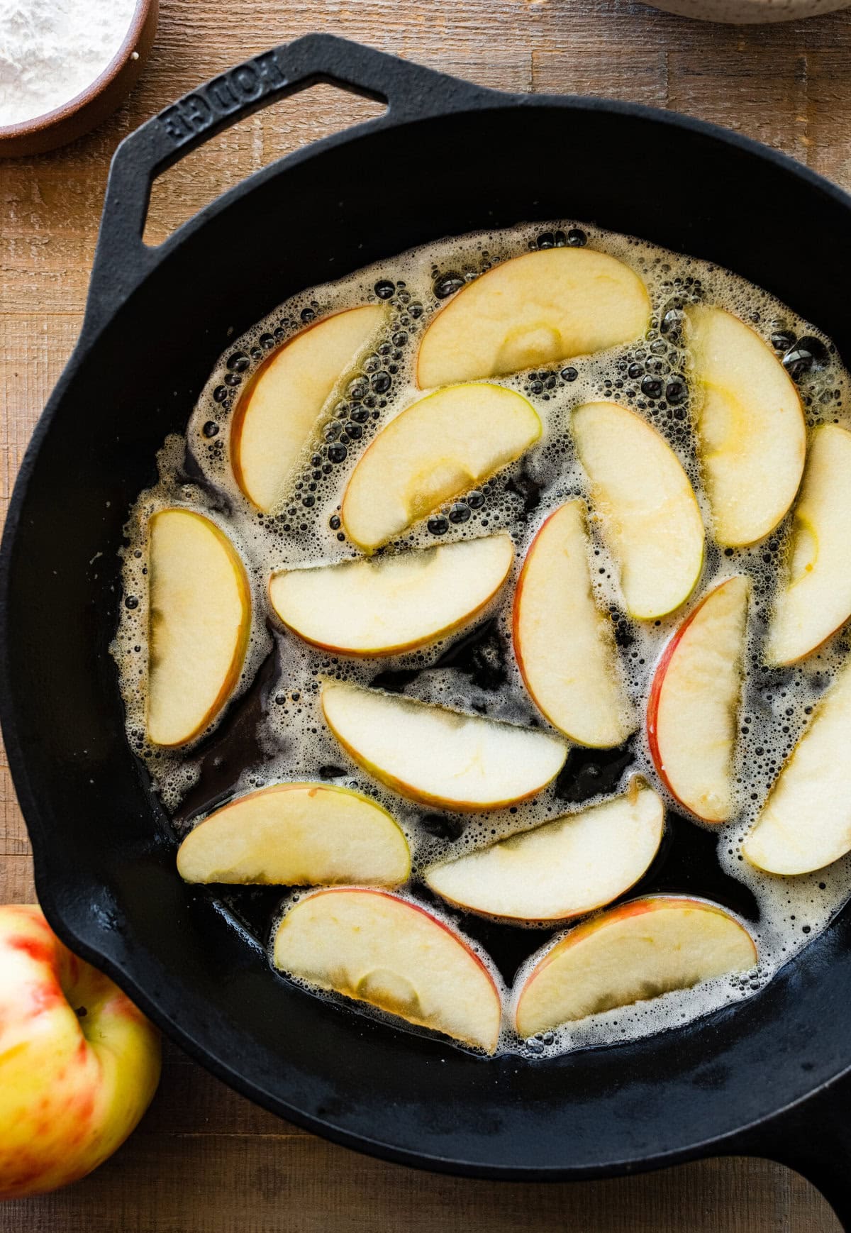 How to make German Apple Pancake- adding the apples to the pan with butter and frying.
