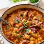Instant Pot Navy Bean Soup with Ham Recipe in a serving bowl with a spoon ready to eat.