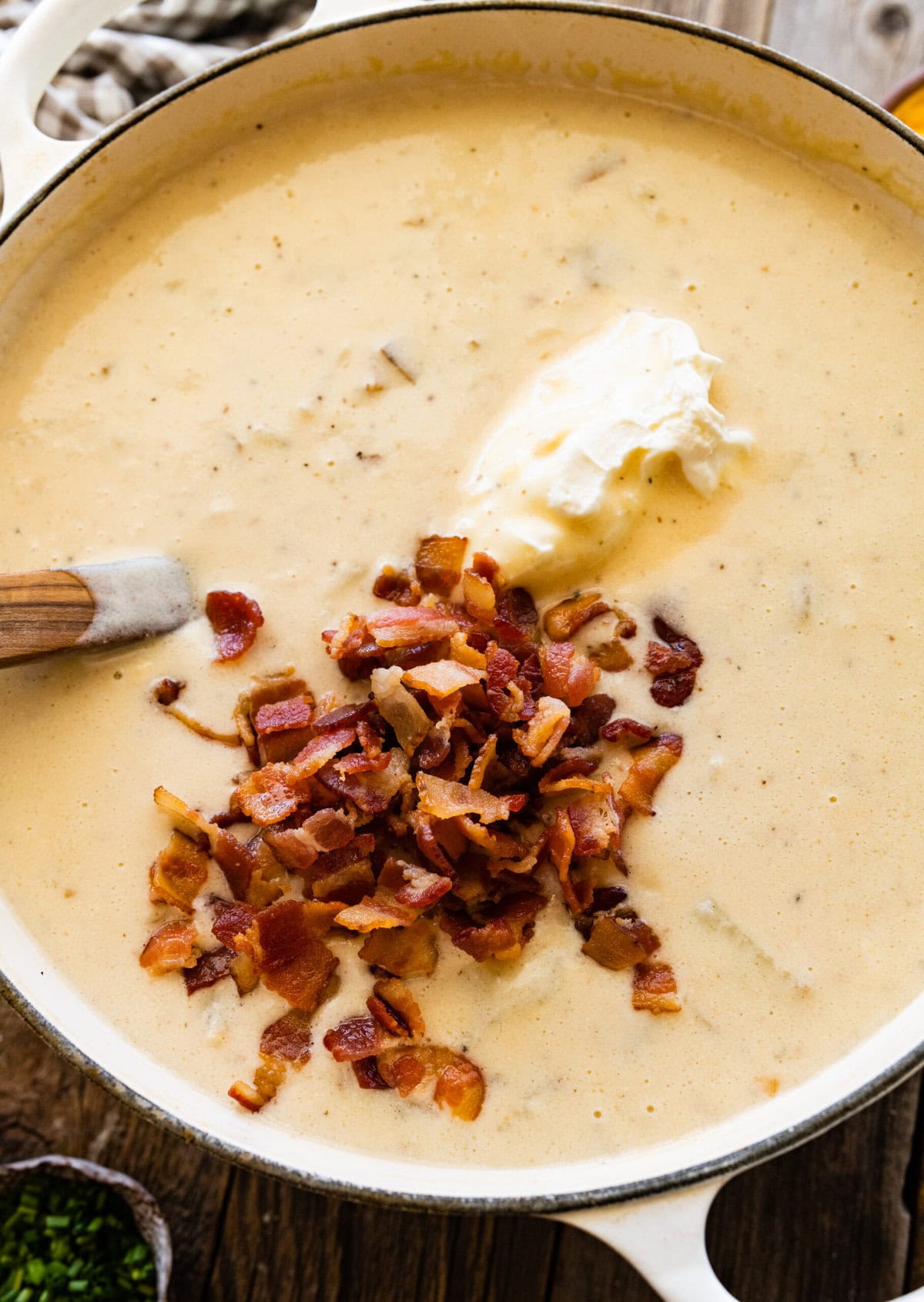 How to make Best Outback Baked Potato Soup Copycat Recipe - add the sour cream and the bacon to the pot.
