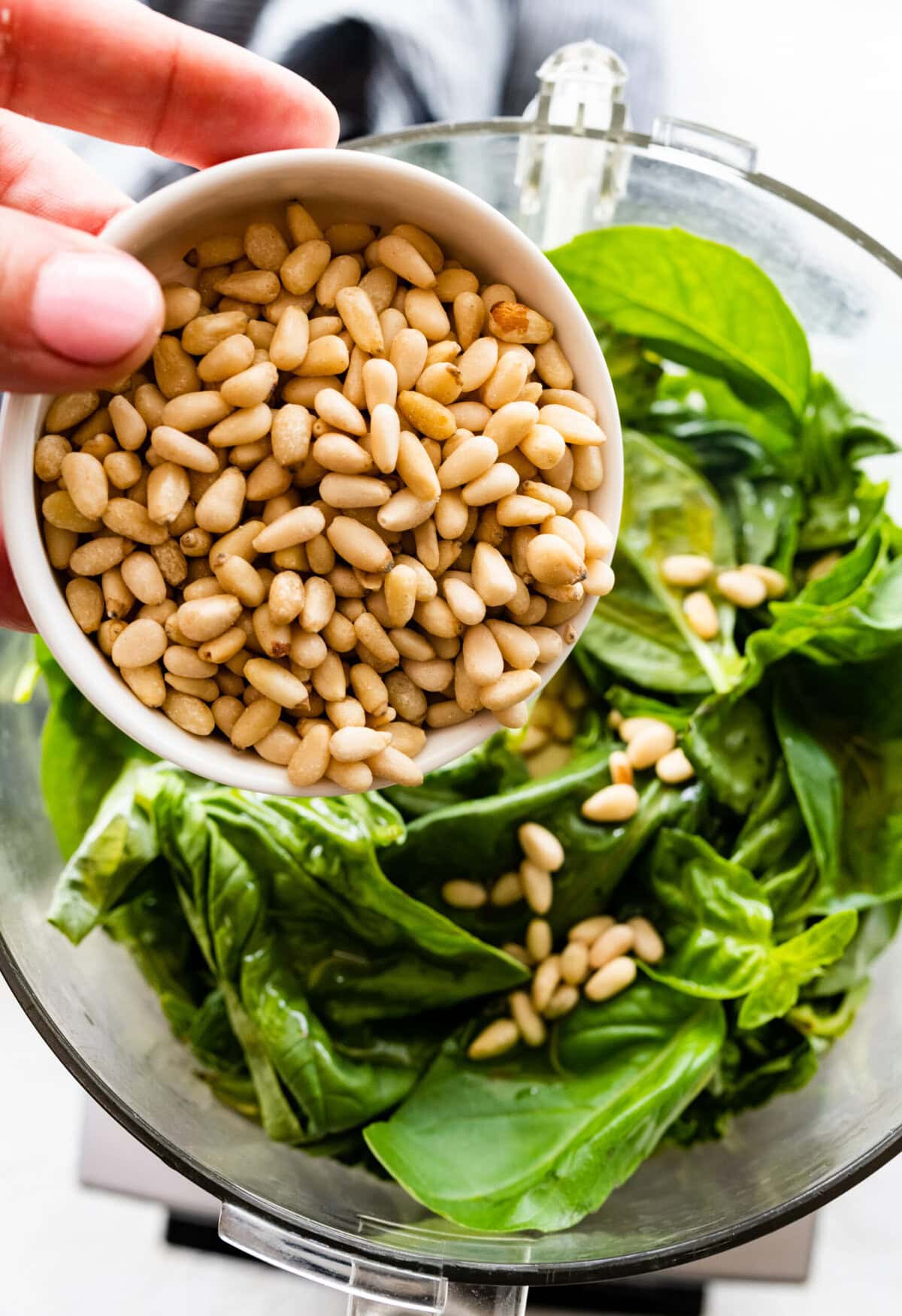 how to make basil pesto- add the pine nuts to the blender.