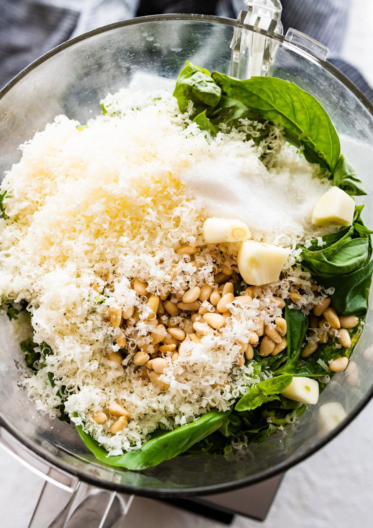 how to make basil pesto- add the cheese and garlic to the blender.