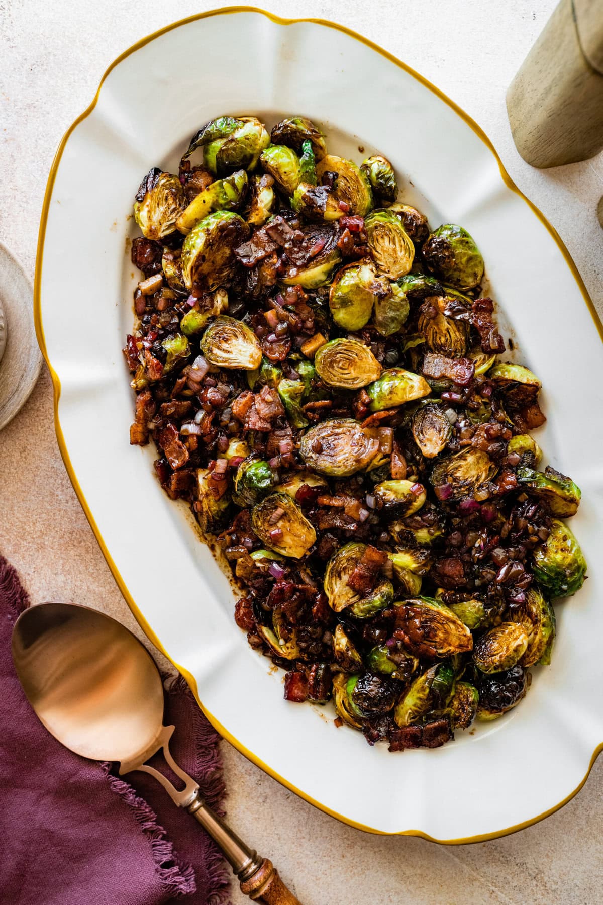 platted Brussels Sprouts with Bacon and Balsamic Recipe on a long white serving platter.