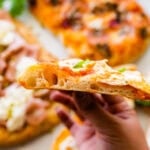 Pinsa Romana Recipe (Roman style pizza dough) - all versions of the finished pinsa ready to eat. Hand holding the cut pinsa. So good!