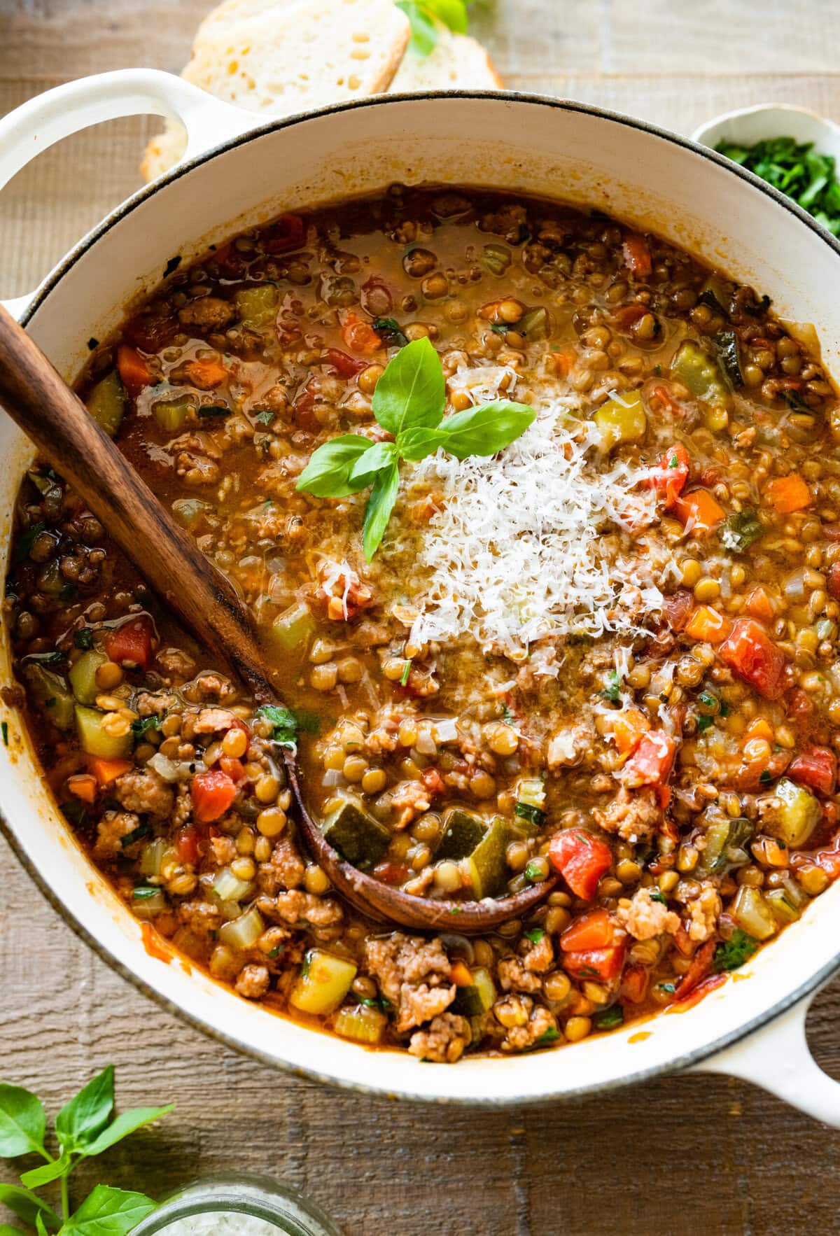 Finished soup in the pot with a little parmigiano cheese and basil.