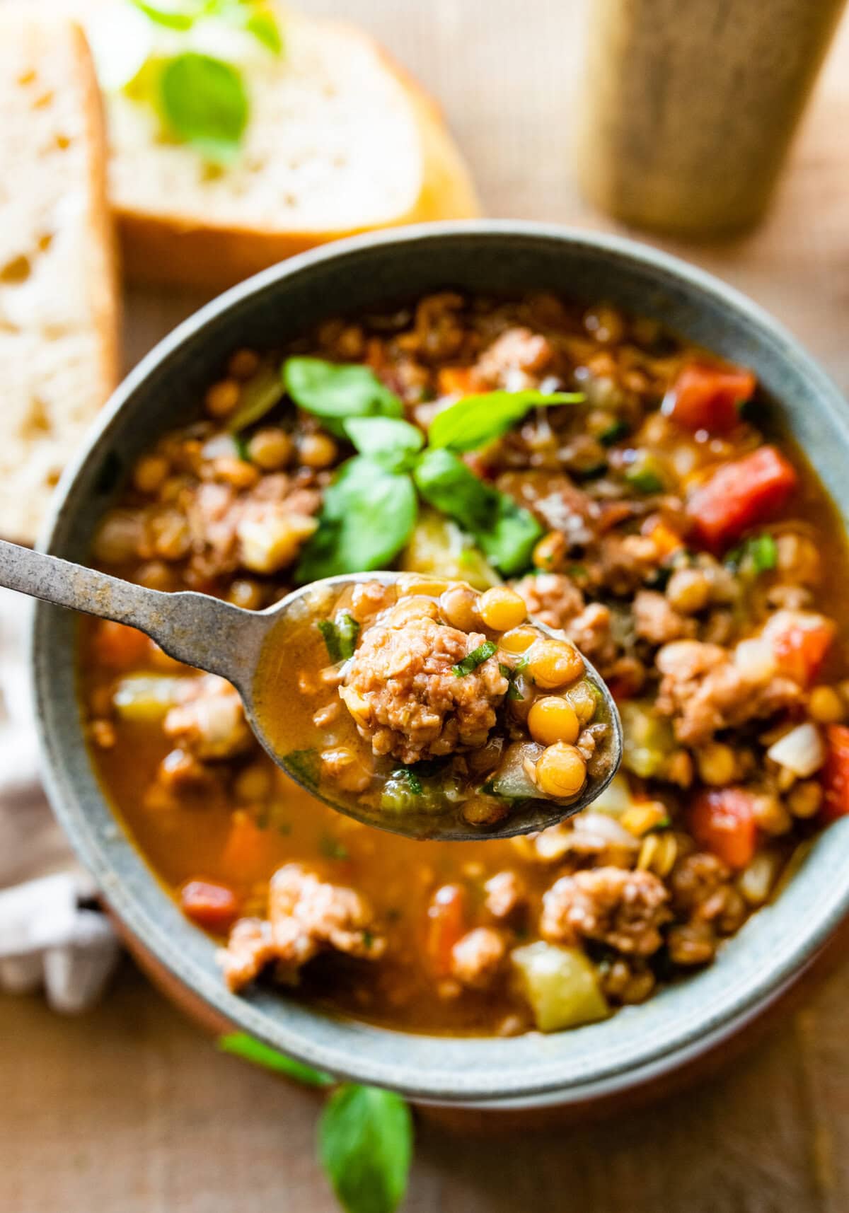 bowl of soup with spoon holding up a bite.