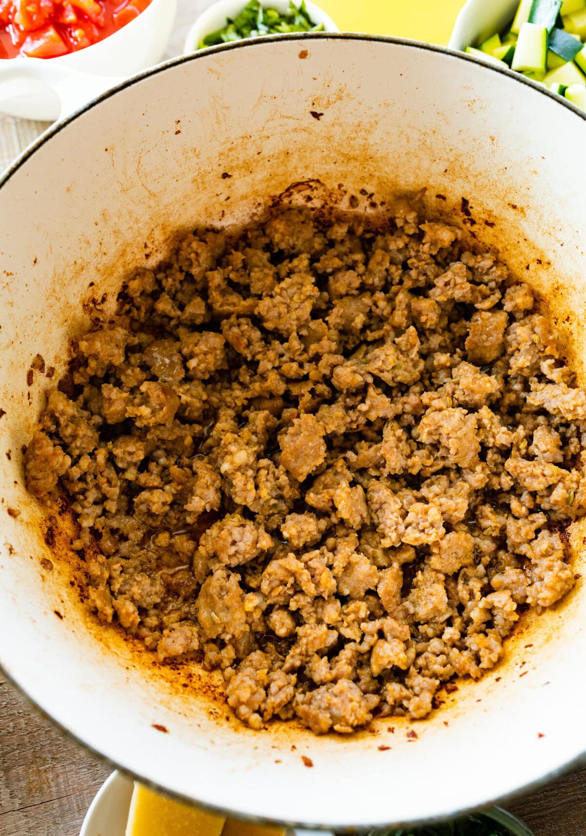 How to make sausage lentil soup (Italian recipe) step-by-step: crumble the sausage and cook in the cast iron pan.