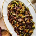 platted Brussels Sprouts with Bacon and Balsamic Recipe on a long white serving platter.