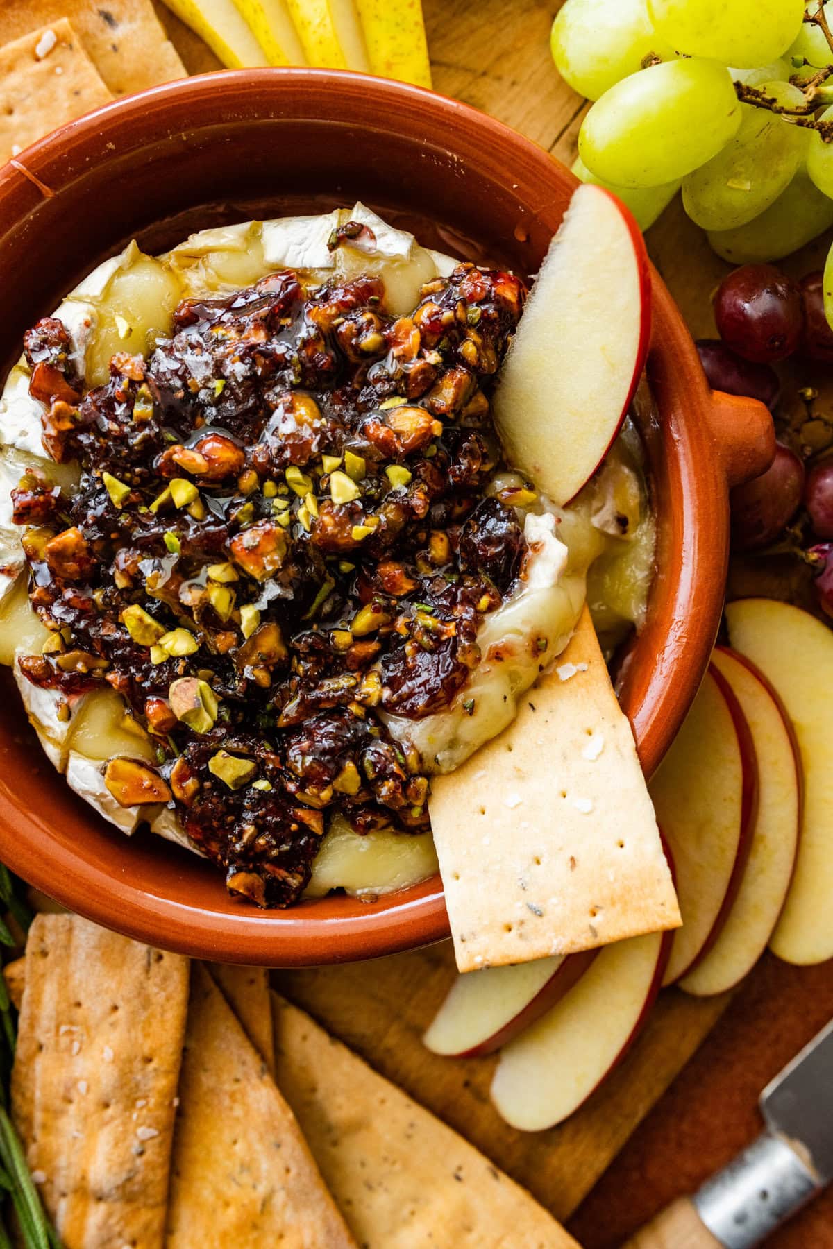 crackers and thin apple slices in the melty cheese with the savory jam and nut topping.