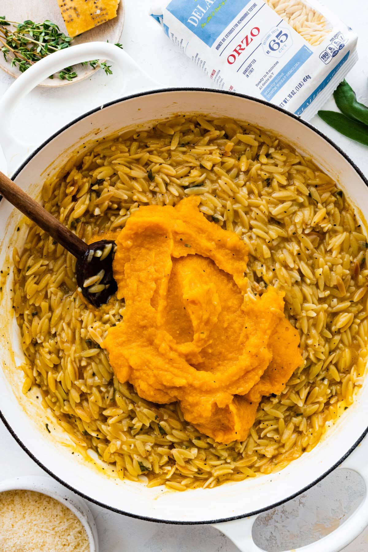 How to make Butternut Squash Orzo Recipe Step-by-step: add the pureed squash to the pot of cooked orzo.