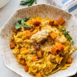 Bowl of the finished butternut squash orzo with a fork ready to eat.