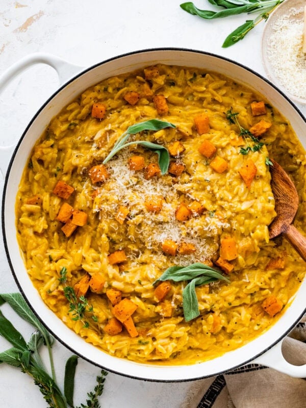 finished butternut squash orzo recipe dish in the pot with sage on top.