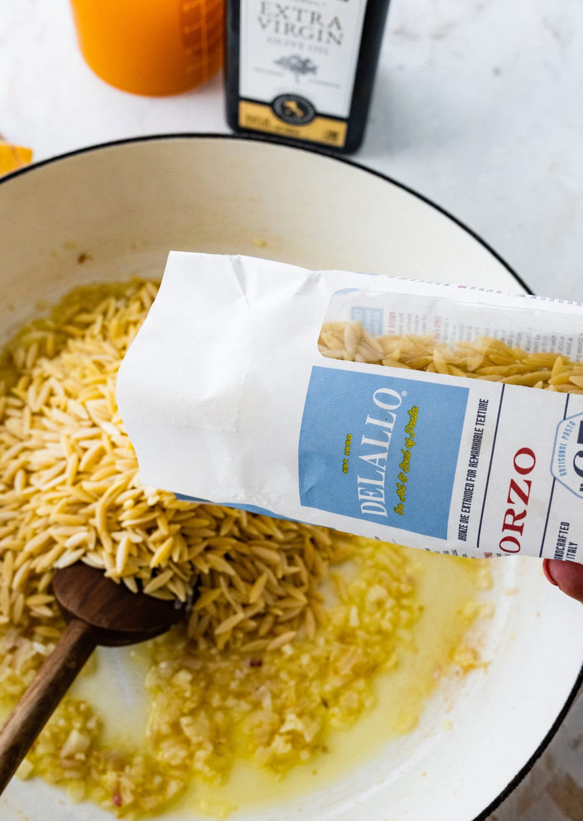 How to make Butternut Squash Orzo Recipe Step-by-step: add the orzo to the pot with oli and shallot.
