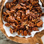 Easy Candied Pecans Recipe in a wooden serving platter.