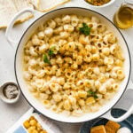 Easy cheese pasta sauce in a serving pot with ingredients around the side.