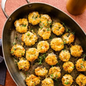 baked stuffed mushrooms with golden brown tops in the pan.