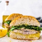 porchetta sandwich ready to eat. Sandwich on a cutting board.
