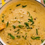 potato corn chowder recipe in a soup pot with a ladle ready to serve.