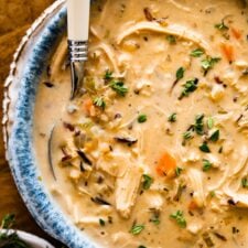 Spoon in a bowl of Creamy Chicken Wild Rice Soup.