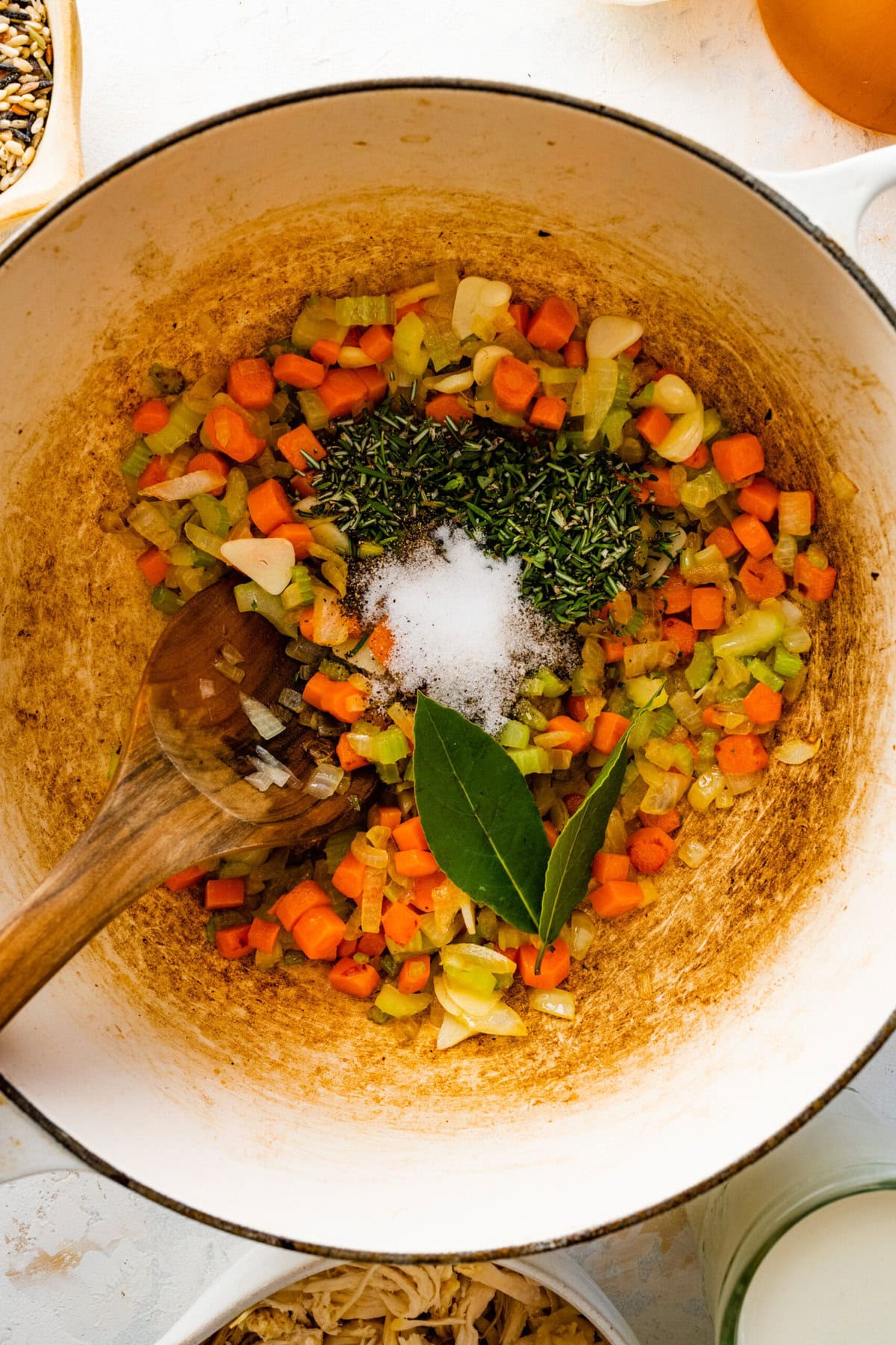 How to make creamy chicken wild rice soup step-by-step photos: add the aromatics to the pot with veggies.