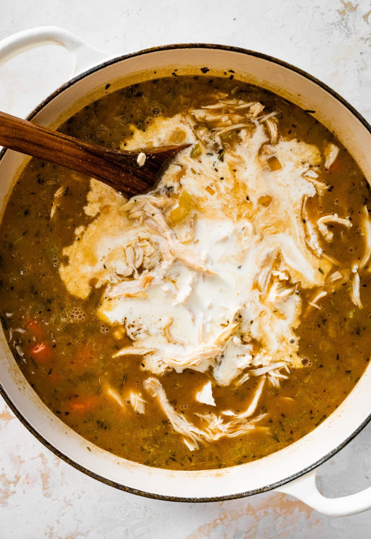 How to make creamy chicken wild rice soup step-by-step photos: add cream and stir and cook to thicken.