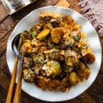 Parmesan Brussels Sprouts Recipe on a serving platter with serving utensils ready to serve.