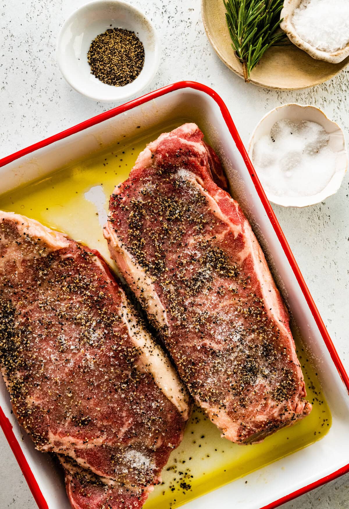 How to make broiled New York Steak step-by-step: season both sides of the steak.
