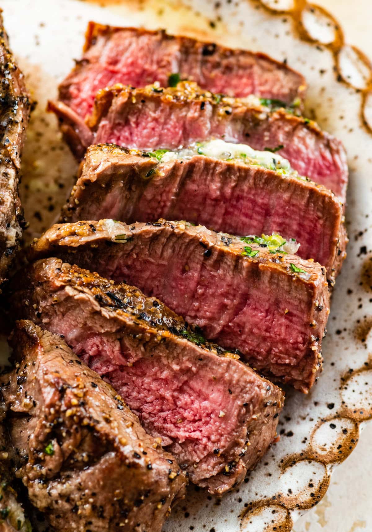 Slice grilled filet mignon on the plate with a medium rare look.