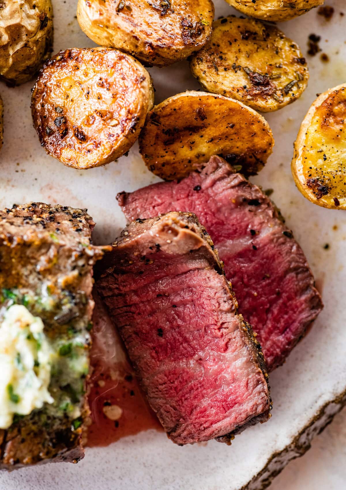Slice grilled filet mignon on the plate with a medium rare look.