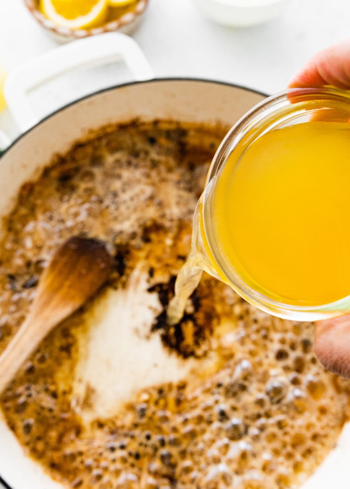 Make the creamy lemon sauce in the pan with cream, broth, and lemon juice.