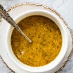 parmesan vinaigrette salad dressing in a bowl with a silver spoon.