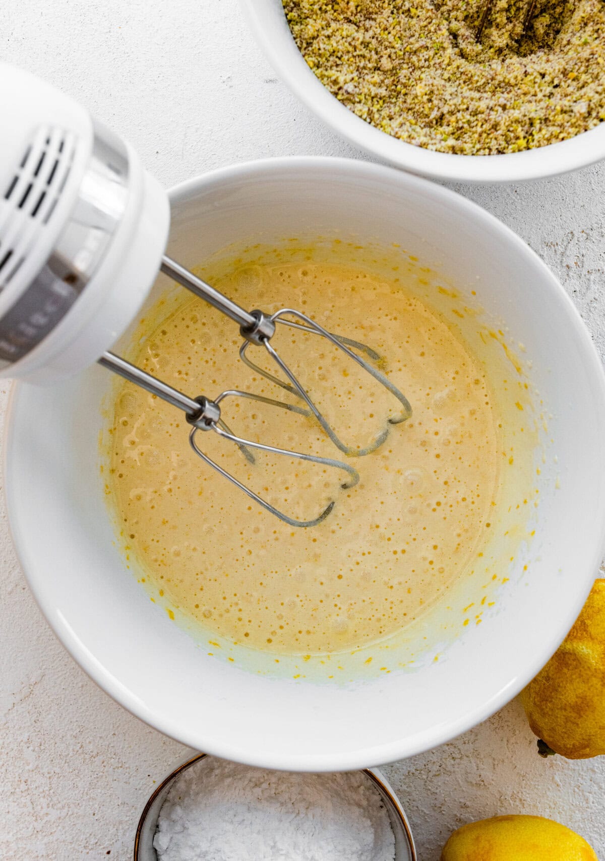 Making Italian Pistachio Cookies- beat the egg mixture until pale yellow with handheld beaters.