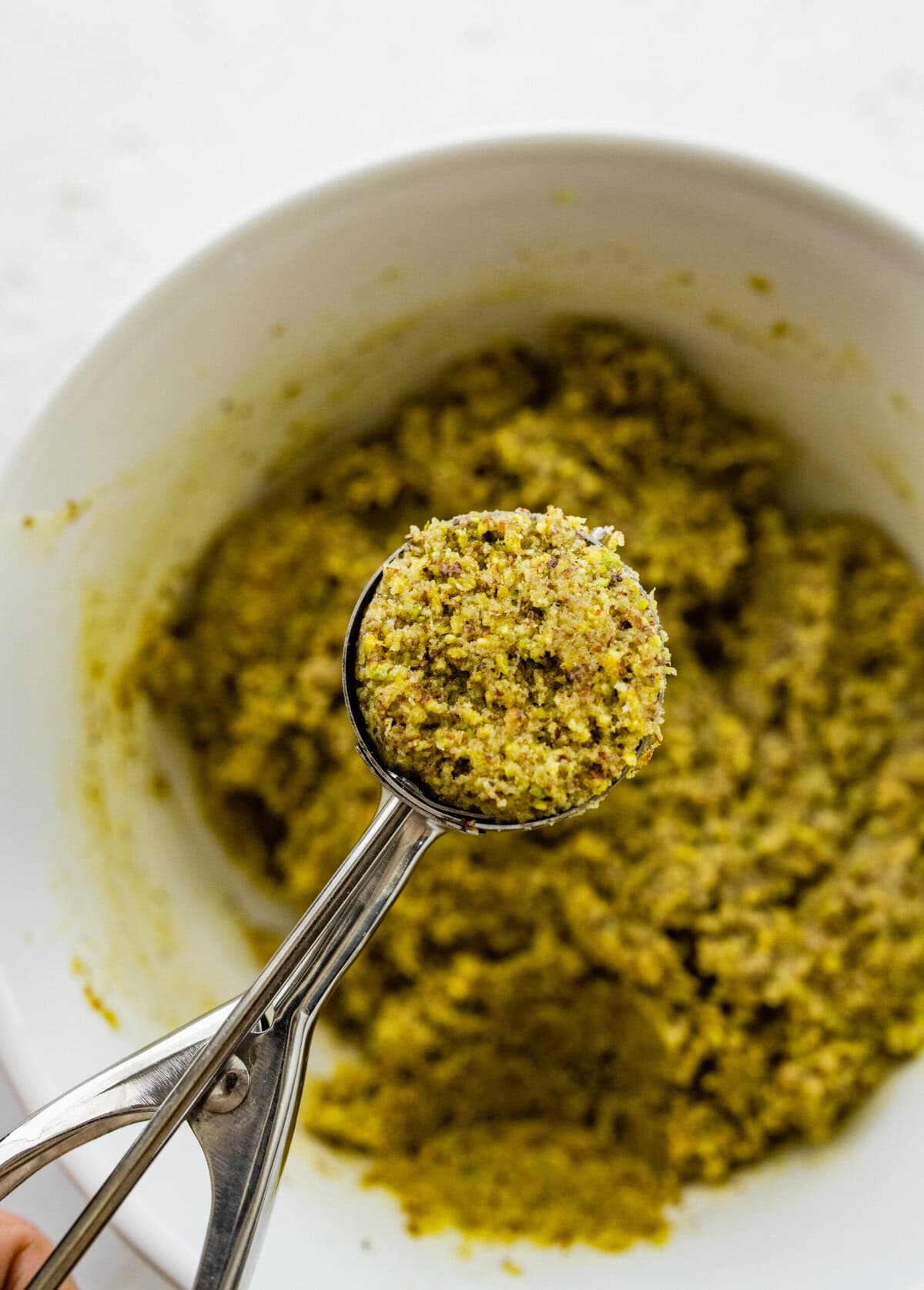 Making Italian Pistachio Cookies- cookie dough in a cookie scoop.
