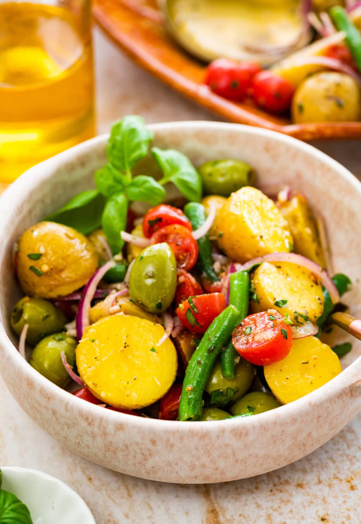 Italian potato salad in a white bowl ready to eat.