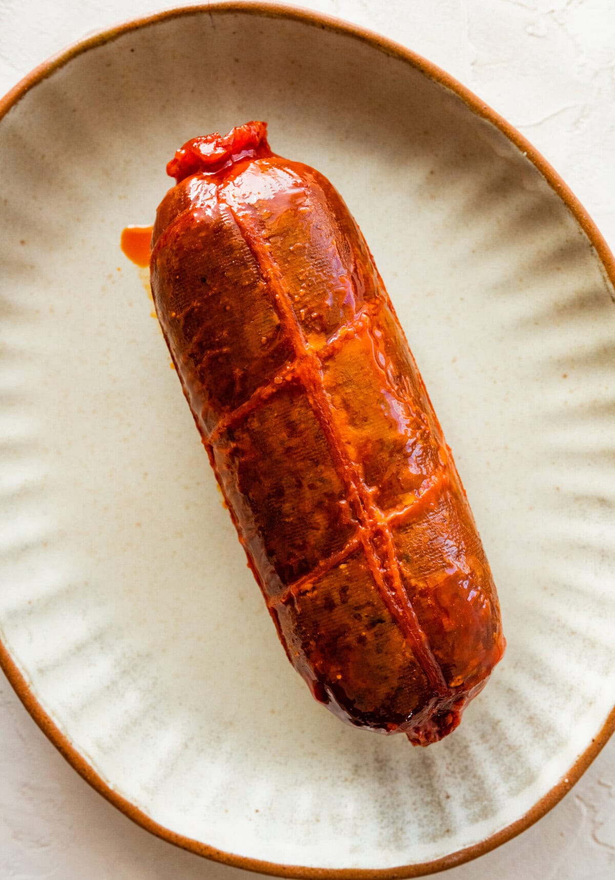 nduja spicy sausage on a plate in a single log.