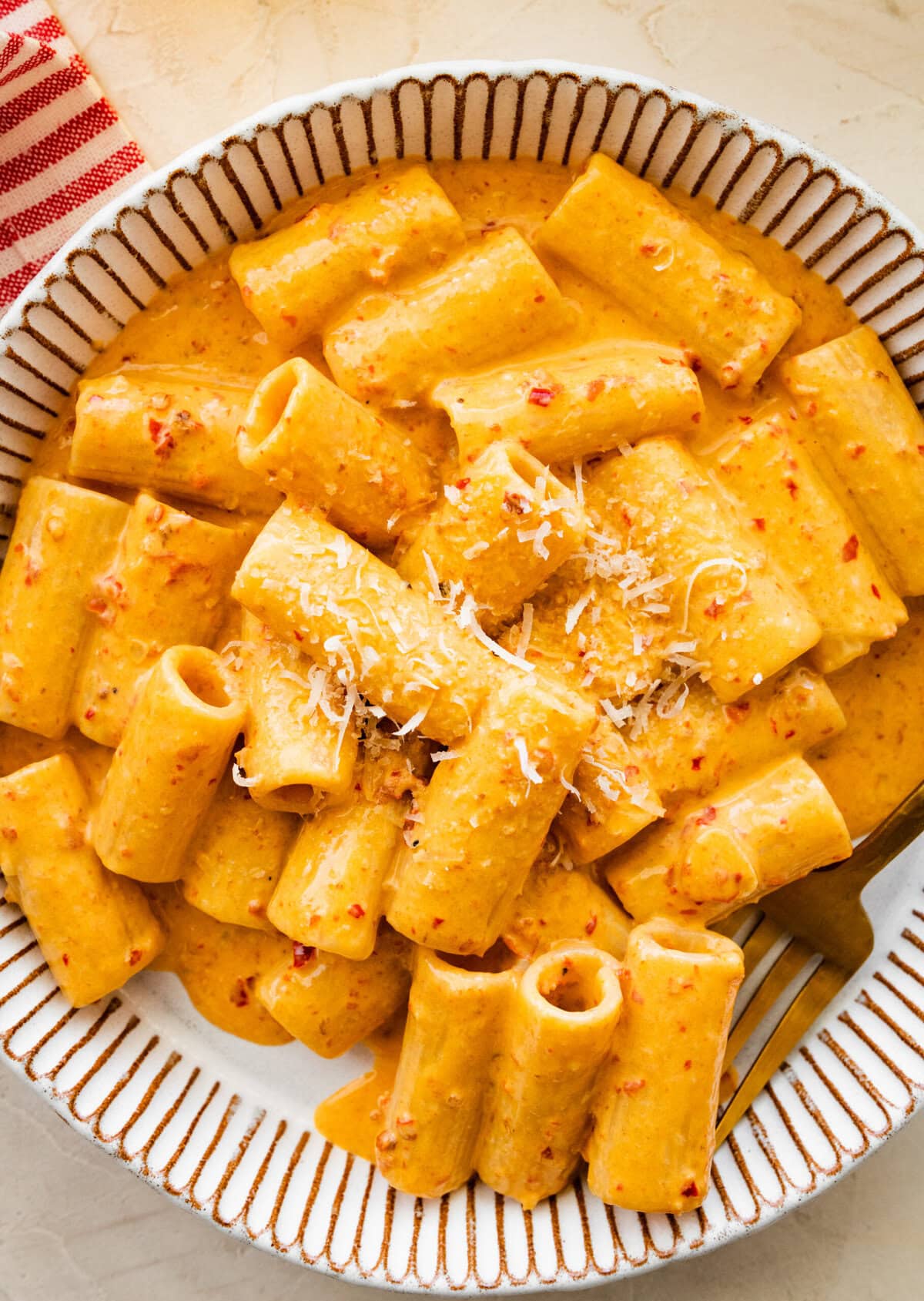 creamy nduja pasta in a bowl with a fork.