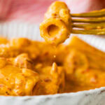 creamy nduja pasta in a bowl with a fork.